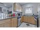 Well-equipped kitchen with wood cabinets and granite countertop at 5650 E Sahara Ave # 1012, Las Vegas, NV 89142