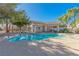 Community pool with surrounding landscaping and building at 5650 E Sahara Ave # 1012, Las Vegas, NV 89142