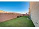 Private backyard with artificial turf and patio furniture at 5694 Colbert St, North Las Vegas, NV 89081