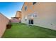 Private backyard with artificial turf and patio furniture at 5694 Colbert St, North Las Vegas, NV 89081