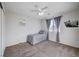 Bright bedroom with grey carpet and ceiling fan at 5694 Colbert St, North Las Vegas, NV 89081