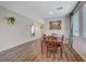 Bright dining room with hardwood floors and a wood table at 5694 Colbert St, North Las Vegas, NV 89081