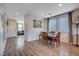 Open concept dining area with hardwood floors, table and chairs at 5694 Colbert St, North Las Vegas, NV 89081