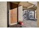 Front door with adjacent garage and potted plant at 5694 Colbert St, North Las Vegas, NV 89081