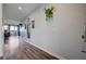 Long hallway with wood floors and mirrors on the wall at 5694 Colbert St, North Las Vegas, NV 89081