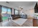 Open living room with sectional sofa, hardwood floors, and backyard access at 5694 Colbert St, North Las Vegas, NV 89081