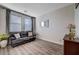 Living room with a leather couch and wood-look floors at 5694 Colbert St, North Las Vegas, NV 89081