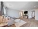 Spacious loft area with gray sectional sofa and a TV at 5694 Colbert St, North Las Vegas, NV 89081