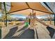 Community playground with shaded areas and play equipment at 5694 Colbert St, North Las Vegas, NV 89081