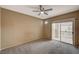 Simple bedroom with a ceiling fan, wall to wall carpet and sliding glass doors to a balcony at 5855 Valley Dr # 2045, North Las Vegas, NV 89031