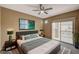 Well-lit bedroom with a large bed, ceiling fan, and sliding glass doors to a balcony at 5855 Valley Dr # 2045, North Las Vegas, NV 89031