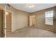 A carpeted bedroom featuring a window and doors to closet and bathroom at 5855 Valley Dr # 2045, North Las Vegas, NV 89031