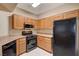 Functional kitchen featuring stainless steel microwave, black appliances, and ample wood cabinets at 5855 Valley Dr # 2045, North Las Vegas, NV 89031