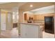 Charming kitchen features wood cabinets, granite countertops, and modern black appliances at 5855 Valley Dr # 2045, North Las Vegas, NV 89031