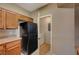Kitchen area featuring cabinets and a black refrigerator at 5855 Valley Dr # 2045, North Las Vegas, NV 89031