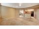 Spacious living room with neutral carpet, open layout, and a view into the adjoining kitchen at 5855 Valley Dr # 2045, North Las Vegas, NV 89031