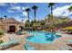 Community pool area showcasing the pool, lounge chairs, palm trees, and clubhouse at 5855 Valley Dr # 2045, North Las Vegas, NV 89031