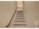 Carpeted staircase with handrail leading to the upper level of this charming home at 5855 Valley Dr # 2045, North Las Vegas, NV 89031