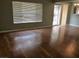 Living room with hardwood floors and a large window at 6681 Bubbling Brook Dr # A, Las Vegas, NV 89107