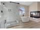 Bathroom with walk-in shower, soaking tub, and modern fixtures at 7457 Painted Shadows Way, Las Vegas, NV 89149