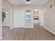 Bright entryway with wood-look floors, white door, and view into kitchen at 7457 Painted Shadows Way, Las Vegas, NV 89149