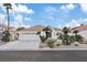 Front view of a single-story house with a two-car garage at 7457 Painted Shadows Way, Las Vegas, NV 89149