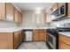 Kitchen with wood cabinets, stainless steel appliances and tile floor at 774 Peregrine Falcon St, Henderson, NV 89015