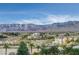 Aerial view of houses, palm trees, and mountain range at 9101 Alta Dr # 502, Las Vegas, NV 89145