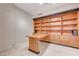 Home office with built-in wooden shelving and desk at 9101 Alta Dr # 502, Las Vegas, NV 89145