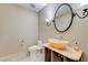 Elegant powder room with modern vanity and oval mirror at 9101 Alta Dr # 502, Las Vegas, NV 89145