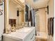 Updated bathroom featuring a white sink vanity, gold fixtures, decorative accents, and a tile shower with curtain at 919 Havre Ave, Henderson, NV 89015