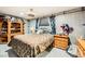 Thematic bedroom with a double bed, wooden furniture and brick feature wall at 919 Havre Ave, Henderson, NV 89015