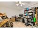 Functional bedroom/office space featuring a bed, desk, shelving, and wood-look flooring at 919 Havre Ave, Henderson, NV 89015