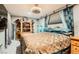 Cozy bedroom with a custom bed, ceiling fan, brick accent wall, decor, and adjacent closet at 919 Havre Ave, Henderson, NV 89015