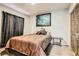 Cozy bedroom features wood-look floors, a comfortable bed, and dark curtains for a relaxing ambiance at 919 Havre Ave, Henderson, NV 89015