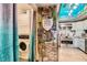 Unique kitchen design with an adjacent laundry area, custom cabinets, granite counters, and stainless appliances at 919 Havre Ave, Henderson, NV 89015
