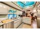 Open kitchen with granite counters, stainless steel appliances, and ocean-themed decor at 919 Havre Ave, Henderson, NV 89015