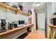 Small kitchen with shelves, appliances, and a door for convenient access at 919 Havre Ave, Henderson, NV 89015