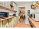 Functional kitchen with shelving, cabinets, appliances, and a view to adjacent sitting room at 919 Havre Ave, Henderson, NV 89015