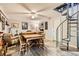 Open-concept living room with a spiral staircase, a dining area, plush seating, and wood-look flooring at 919 Havre Ave, Henderson, NV 89015