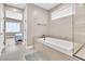 Bathroom with soaking tub, shower, and view into bedroom at 10301 Fairview Ridge Ct, Las Vegas, NV 89166