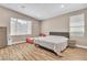 Spacious bedroom with large bed, additional sleeping space, and light wood floors at 10301 Fairview Ridge Ct, Las Vegas, NV 89166