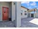 Side entrance with modern brick pathway and orange door at 10301 Fairview Ridge Ct, Las Vegas, NV 89166