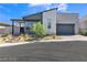 Modern single Gathering home featuring a two-car garage, drought-tolerant landscaping, and a neutral color palette at 10301 Fairview Ridge Ct, Las Vegas, NV 89166