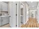 Clean hallway with light wood floors and access to bathroom and laundry at 10301 Fairview Ridge Ct, Las Vegas, NV 89166