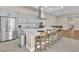 Spacious kitchen featuring stainless steel appliances, gray cabinets, a large island with seating, and tile flooring at 10301 Fairview Ridge Ct, Las Vegas, NV 89166