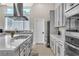 Gray kitchen cabinets, stainless steel appliances, and island at 10301 Fairview Ridge Ct, Las Vegas, NV 89166