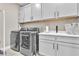 Bright laundry room with washer, dryer, and ample cabinetry at 10301 Fairview Ridge Ct, Las Vegas, NV 89166