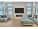Living room with built-in fireplace and large TV at 10301 Fairview Ridge Ct, Las Vegas, NV 89166