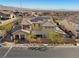 Stunning aerial view of a home with a tile roof, solar panels, landscaped yard, and neighborhood at 10729 Beecher Park Ave, Las Vegas, NV 89166
